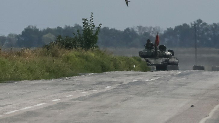 A pro-Russian separatist tank is seen near a checkpoint of the Ukrainian national guard nearby the town of Slavyanoserbsk, in Luhansk region